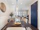 Elegant dining room with a long dark wood table and decorative light fixture, flowing into a cozy living space at 345 Glen Iris Ne Dr # 5, Atlanta, GA 30312