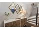 Beautiful foyer with modern console table, diamond mirrors, dark wood floors and staircase at 345 Glen Iris Ne Dr # 5, Atlanta, GA 30312