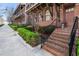 Brick townhouse with elegant entryway, black railings and tidy shrubbery along a concrete walkway at 345 Glen Iris Ne Dr # 5, Atlanta, GA 30312