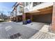 Street view of townhome garages featuring brick columns and brick paver driveway at 345 Glen Iris Ne Dr # 5, Atlanta, GA 30312