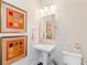 Stylish half bathroom features a pedestal sink, decorative art, and a clean, modern design at 345 Glen Iris Ne Dr # 5, Atlanta, GA 30312