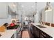 Open kitchen featuring white countertops, stainless appliances, and dark wood floors leading to a dining area at 345 Glen Iris Ne Dr # 5, Atlanta, GA 30312