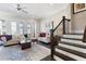 Bright living room showcasing elegant seating, a staircase, and access to a balcony with city views at 345 Glen Iris Ne Dr # 5, Atlanta, GA 30312