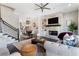Open-concept living room with a tiled fireplace, built-in shelves, and seamless transition to the dining area at 345 Glen Iris Ne Dr # 5, Atlanta, GA 30312