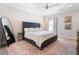 Serene main bedroom features a tufted headboard bed, soft rug, ample lighting, and decorative mirror at 345 Glen Iris Ne Dr # 5, Atlanta, GA 30312