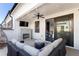 Relaxing covered patio with a stone fireplace, comfortable seating, and access to the indoors through sliding doors at 345 Glen Iris Ne Dr # 5, Atlanta, GA 30312