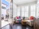Sunny sitting area with armchairs, shutters, and access to the outdoor deck at 345 Glen Iris Ne Dr # 5, Atlanta, GA 30312