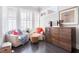 Bright sitting area with comfortable armchairs, shutters, and a charming wooden cabinet at 345 Glen Iris Ne Dr # 5, Atlanta, GA 30312