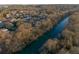 Aerial shot of a neighborhood along a river, surrounded by trees and greenery at 3816 Turnberry Ct, Duluth, GA 30096