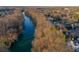 Aerial shot of a community with houses along a river surrounded by bare trees at 3816 Turnberry Ct, Duluth, GA 30096