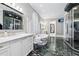 Spacious bathroom with marble floors, soaking tub, marble shower, and a vanity with white cabinets at 3816 Turnberry Ct, Duluth, GA 30096