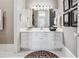 Clean bathroom with large mirror, white vanity, tile floor, and decorative accents at 3816 Turnberry Ct, Duluth, GA 30096