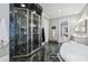 Elegant bathroom featuring a marble shower, floors, and a modern soaking tub at 3816 Turnberry Ct, Duluth, GA 30096