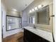 Well-lit bathroom with dark wood vanity, granite countertop, and glass-enclosed shower at 3816 Turnberry Ct, Duluth, GA 30096