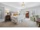 Large bedroom with a bed, dresser, chair, and lots of natural light is spacious and elegant at 3816 Turnberry Ct, Duluth, GA 30096