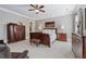 Spacious bedroom with neutral color scheme, ceiling fan and dark wood furniture at 3816 Turnberry Ct, Duluth, GA 30096