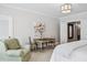 Comfortable bedroom with a table, arm chair, and an attached sitting area provides a retreat within the home at 3816 Turnberry Ct, Duluth, GA 30096