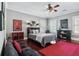 Charming bedroom features hardwood floors, ceiling fan, and a decorative red area rug at 3816 Turnberry Ct, Duluth, GA 30096