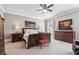 Bedroom suite with dark wood furniture, ceiling fan, neutral colors, and carpet flooring at 3816 Turnberry Ct, Duluth, GA 30096