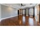 A spacious bedroom showcases gleaming hardwood floors, light gray walls and natural light from the two windows at 3816 Turnberry Ct, Duluth, GA 30096