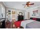 Spacious bedroom with hardwood floors, ceiling fan, ensuite bathroom, and unique décor at 3816 Turnberry Ct, Duluth, GA 30096