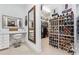 Walk-in closet with custom shelving for shoes and accessories, plus a vanity area with mirror at 3816 Turnberry Ct, Duluth, GA 30096