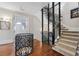Home elevator and staircase featuring modern design, hardwood floors, and decorative railing at 3816 Turnberry Ct, Duluth, GA 30096