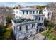 Aerial view of a stately home with a rooftop terrace, three car garage, and manicured lawn at 3816 Turnberry Ct, Duluth, GA 30096