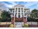 A stately home with brick entryway, grand columns, and wrought iron balconies at 3816 Turnberry Ct, Duluth, GA 30096
