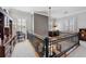 Upstairs hallway with railings overlooking living area below and built in shelves at 3816 Turnberry Ct, Duluth, GA 30096