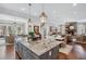 Open concept kitchen and living area with granite island and fireplace at 3816 Turnberry Ct, Duluth, GA 30096