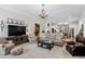 Spacious living room open to the kitchen features hardwood floors and a decorative chandelier at 3816 Turnberry Ct, Duluth, GA 30096