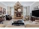 Inviting living room with stone fireplace, chandelier, and neutral color palette at 3816 Turnberry Ct, Duluth, GA 30096