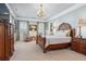 Spacious main bedroom with sitting area, decorative molding, and a chandelier at 3816 Turnberry Ct, Duluth, GA 30096