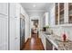 Butler's pantry features granite countertops, white cabinetry, and stainless steel appliances at 3816 Turnberry Ct, Duluth, GA 30096