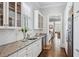 Bright butler's pantry with white cabinetry, granite countertops, and stainless appliances at 3816 Turnberry Ct, Duluth, GA 30096