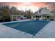 Covered community pool next to large home featuring an outdoor pergola and porch at 3816 Turnberry Ct, Duluth, GA 30096
