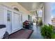 Covered porch with plenty of seating, ornate columns, and a porch swing at 3816 Turnberry Ct, Duluth, GA 30096