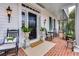 Inviting covered porch with rocking chairs and manicured potted plants at 3816 Turnberry Ct, Duluth, GA 30096