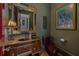 Unique powder room featuring a ornate mirror, dark walls, and vintage-inspired fixtures at 3816 Turnberry Ct, Duluth, GA 30096