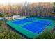 Bright blue and green tennis courts in a community featuring lights and seating at 3816 Turnberry Ct, Duluth, GA 30096