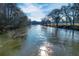 Scenic view of a river surrounded by trees and greenery, reflecting sunlight on the water at 3816 Turnberry Ct, Duluth, GA 30096