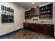 Stylish home bar area with custom cabinetry, granite countertop, and ample storage at 427 Parkbrook Way, Canton, GA 30114