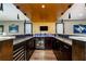 Finished basement with an amazing bar, dark wood cabinets, and cooler at 427 Parkbrook Way, Canton, GA 30114