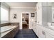 Bright bathroom featuring a soaking tub, spacious vanity, and elegant fixtures at 427 Parkbrook Way, Canton, GA 30114