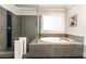Modern bathroom featuring a glass-enclosed shower and separate soaking tub at 427 Parkbrook Way, Canton, GA 30114