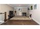 Bonus room with hardwood floors, neutral walls, a TV, and wall art at 427 Parkbrook Way, Canton, GA 30114