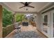 Enjoy the outdoors on this inviting covered deck with ceiling fan and wooded views at 427 Parkbrook Way, Canton, GA 30114