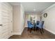 Bright dining room with hardwood floors, a glass table, blue chairs, and a window at 427 Parkbrook Way, Canton, GA 30114