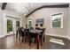 Dining room with hardwood floors, modern chandelier, and access to outdoor deck at 427 Parkbrook Way, Canton, GA 30114